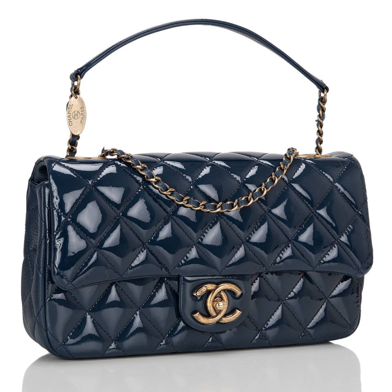 This gorgeous Chanel Navy Quilted Patent Eyelet Flap bag with antiqued gold tone hardware and features a front flap with the signature CC closure, quilted goat skin gussets, half moon back pocket, and an adjustable antiqued gold tone chain link and