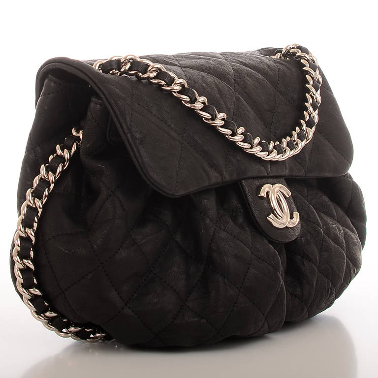 Chanel Black Aged Quilted Lambskin Chain Around Medium Crossbody Messenger Bag with silvertone hardware, ruched leather accent, front flap with CC, hidden snap closure, and interwoven silvertone chain link and leather shoulder strap. Interior is
