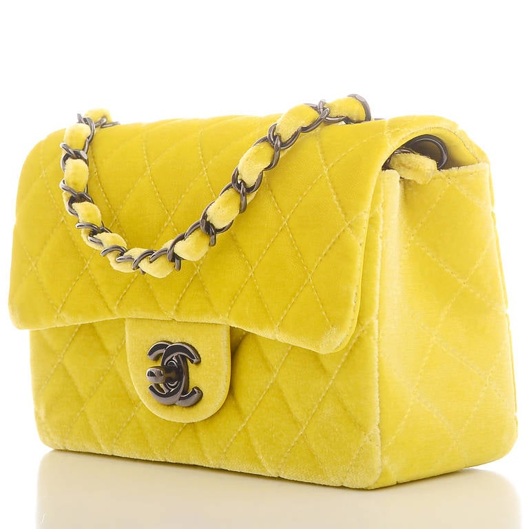 Chanel yellow quilted velvet velour Small classic 2.55 flap bag with gunmetal hardware, front flap with CC turnlock closure, half moon back pocket and interwoven metal chain link and velvet shoulder/crossbody strap. Interior is lined in Yellow