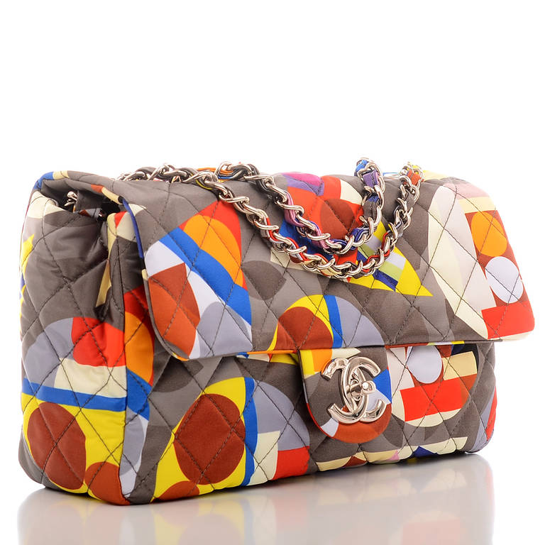Chanel printed nylon quilted flap bag of grey and multi-color Chanel geometric shape design of red, blue, cream, yellow, pink, purple, etc. with CHANEL and CC logos with silvertone hardware, front flap with CC turnlock closure and interwoven metal