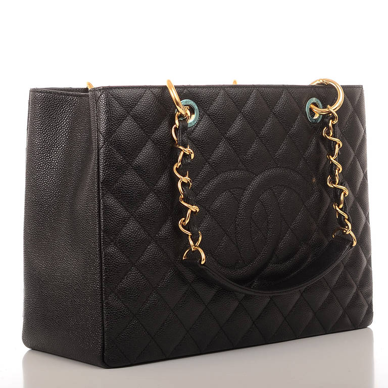 Chanel black quilted caviar leather Grand Shopper Tote (GST) bag with goldtone hardware, front stitched CC logo, half moon back pocket and double interwoven goldtone chain link and leather padded straps. Interior is lined in black fabric with front