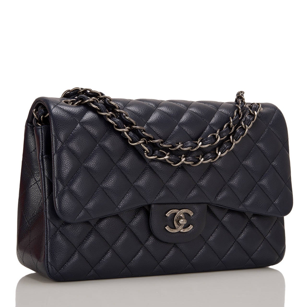 Chanel navy quilted caviar Jumbo Classic double flap bag with aged ruthenium hardware.

This Jumbo Classic double flap of rich navy caviar leather features a front flap with signature CC turnlock closure, half moon back pocket, and an adjustable