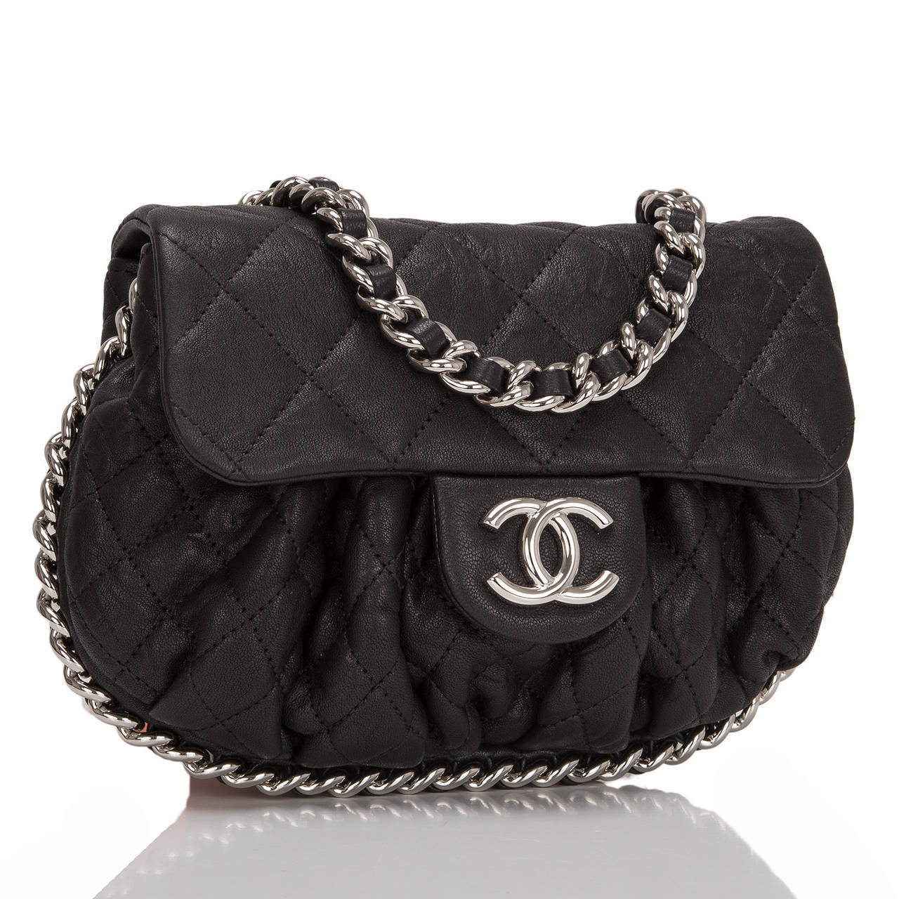 This Chanel black aged quilted lambskin Chain Around Mini crossbody messenger bag features silver tone hardware, ruched leather accent, front flap with CC, hidden snap closure, and interwoven silver tone chain link and leather shoulder strap.

The
