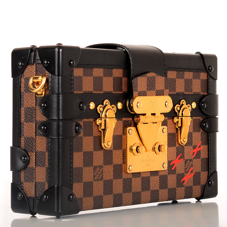 Louis Vuitton Brown checkered Damier Ebene Petite Malle of coated canvas with black smooth leather trim.

This style features golden brass hardware, black metal corners, a foldover strap with LV S-lock closure and a removable adjustable shoulder