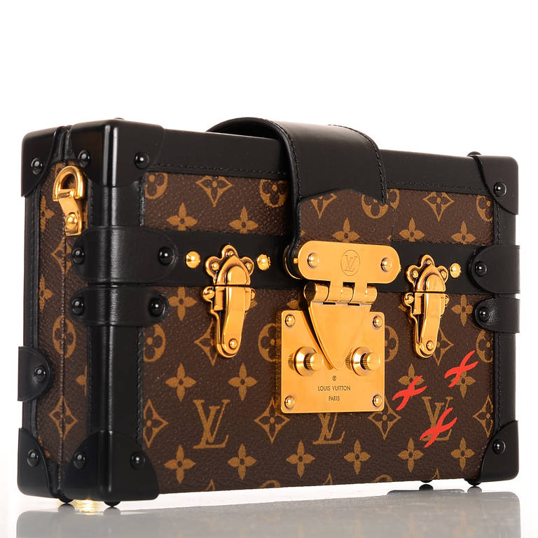 Louis Vuitton Monogram Petite Malle of coated canvas with black smooth leather trim.

This runway style features golden brass hardware, black metal corners, foldover strap with LV S-lock closure and a removable adjustable shoulder strap.

The