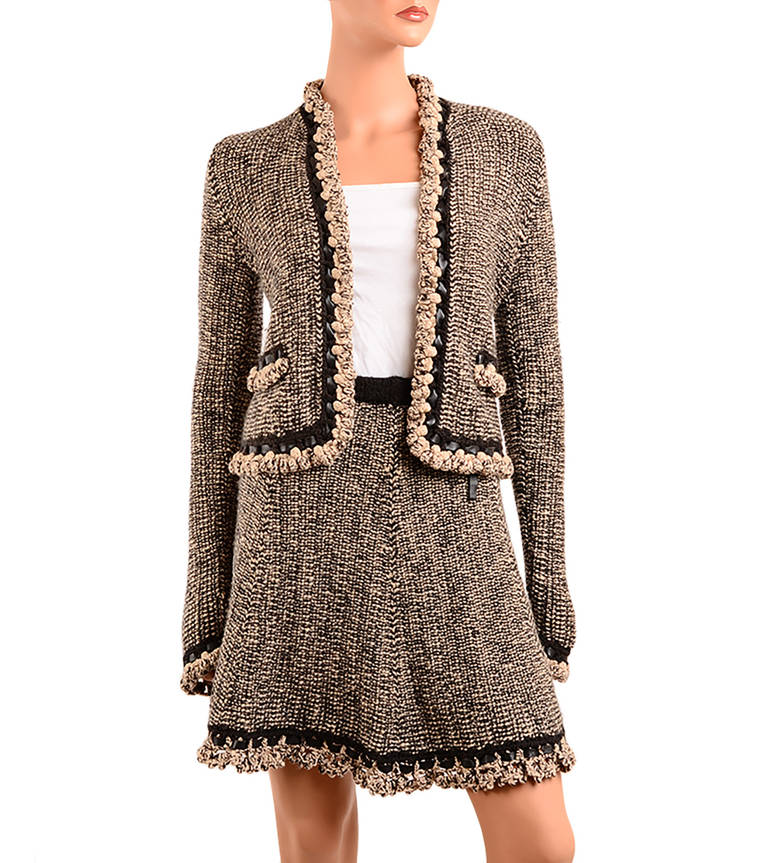 Chanel knit skirt suit of brown and beige tweed comprising jacket with allover scalloped tonal knotted wool and brown leather trim, front leather tie closure, two faux fringed flap pockets and long sleeves; and matching pull-on flare skirt with