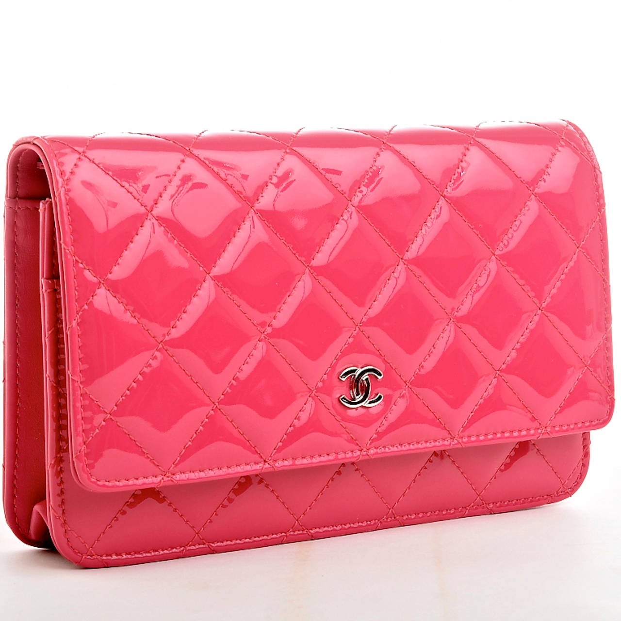 Chanel fuchsia pink Classic Wallet On Chain (WOC) of quilted patent leather and silver tone hardware.

The Wallet On Chain (WOC) is one of the most desired Chanel accessories. Its great styling, versatility and attractive price point makes it a