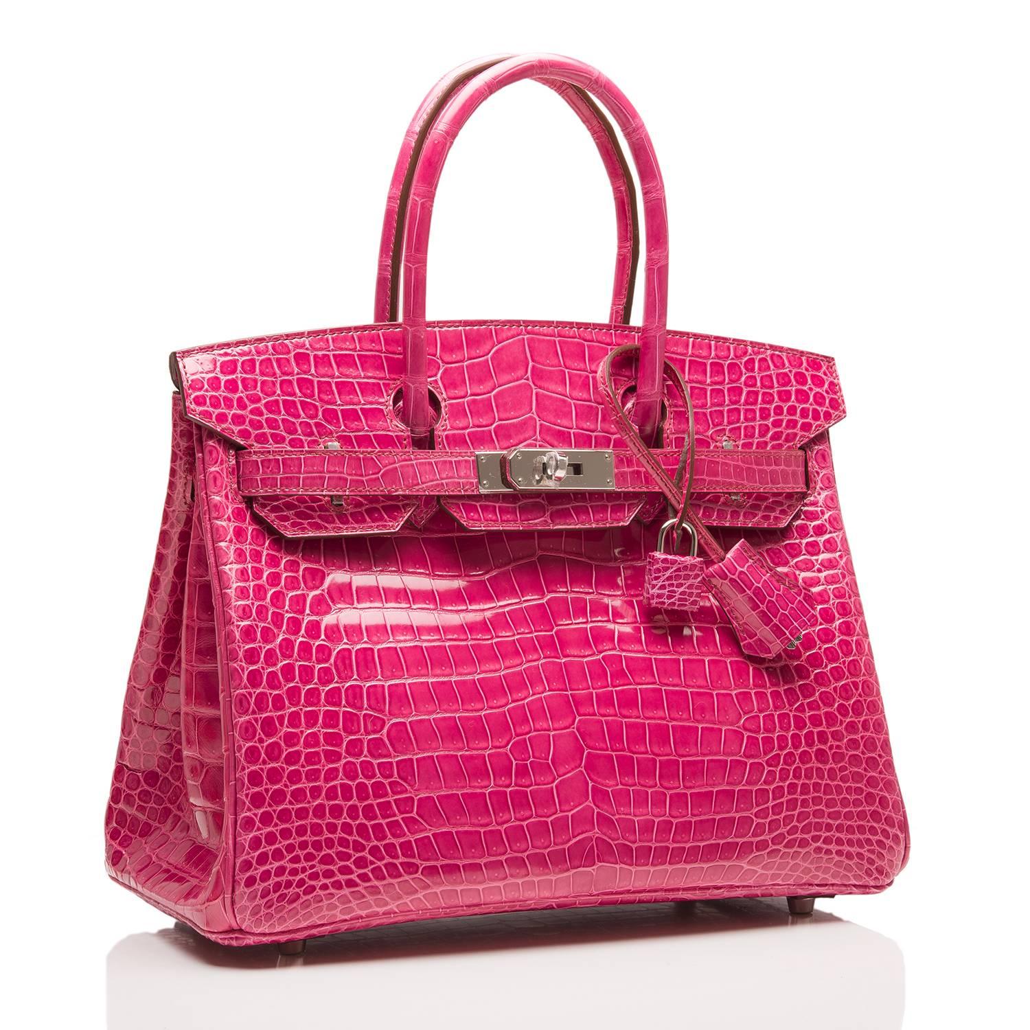 Hermes Fuchsia Birkin 30cm in shiny Porosus crocodile with palladium hardware.

This Birkin features tonal stitching, front toggle closure, clochette with lock and two keys, and double rolled handles. The interior is lined in Fuchsia chevre with