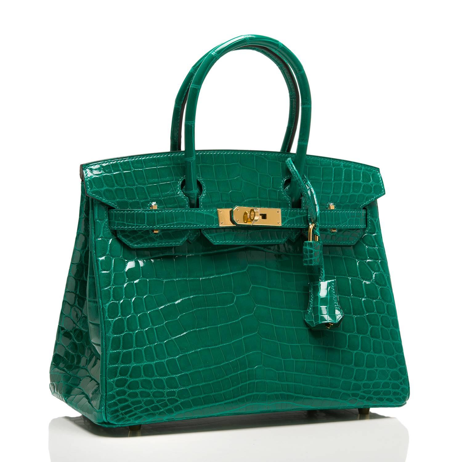 Hermes Emerald (Vert Emeraude) Birkin 30cm in shiny Nilo crocodile with gold hardware.

This Birkin features tonal stitching, front toggle closure, clochette with lock and two keys, and double rolled handles. The interior is lined in Emerald