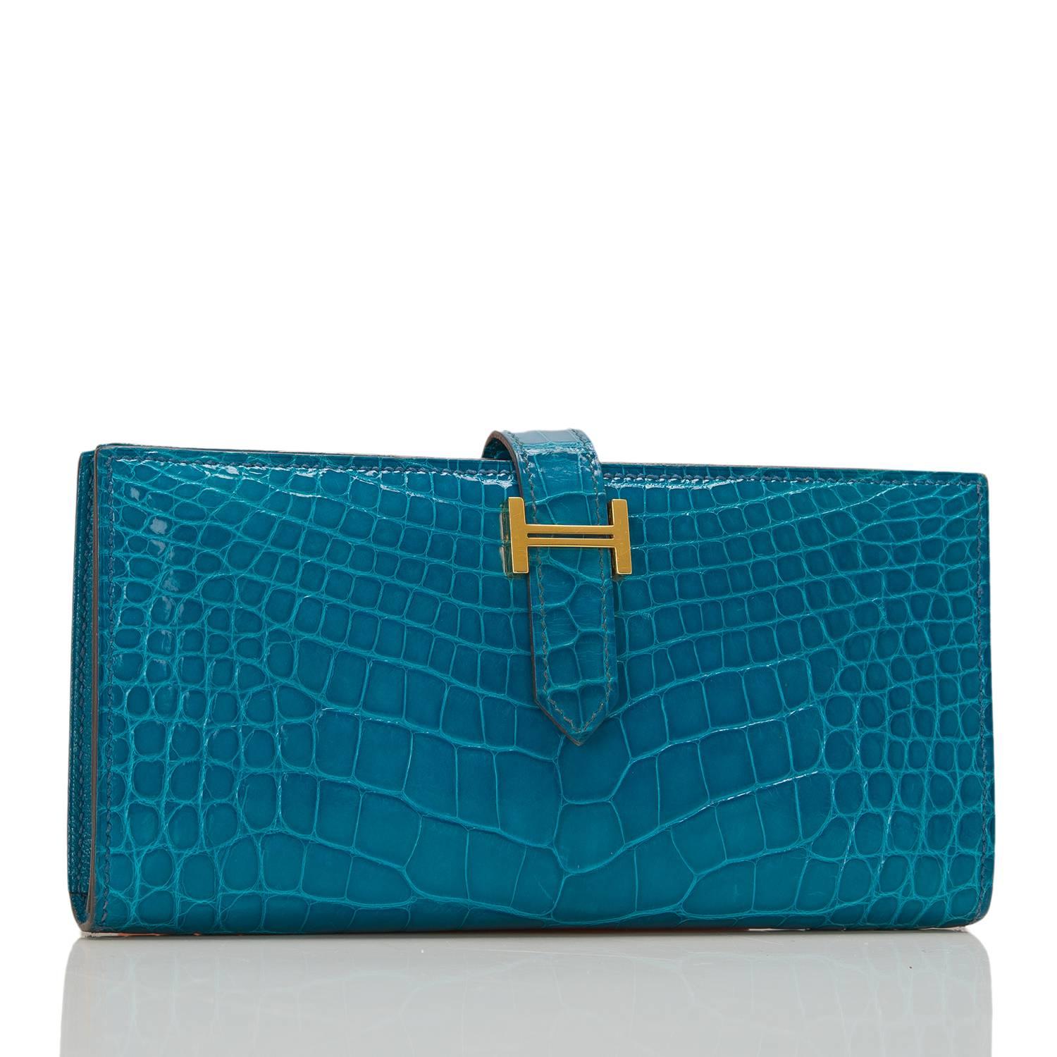 Hermes Blue Izmir Bearn wallet of Alligator with gold hardware.

This style features a front 