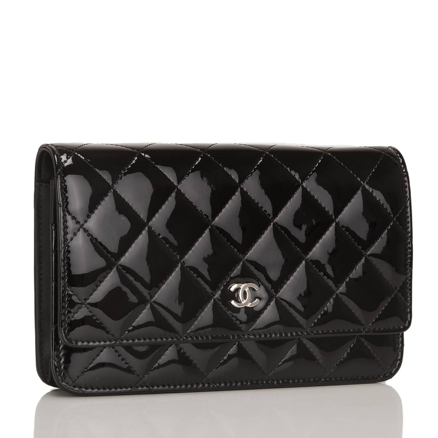  	
This Chanel Wallet On Chain is made of black patent leather and accented with silver tone hardware.

The bag features a front flap with a CC charm and a hidden snap closure, signature Chanel quilting, expandable sides and bottom, a half moon