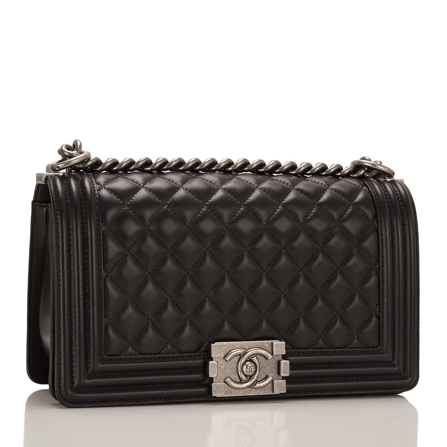 This Chanel Medium Boy bag is made of black lambskin leather and accented with aged ruthenium hardware.

The bag features a full front flap with signature Le Boy CC logo push lock closure and an aged ruthenium chain link and black leather padded