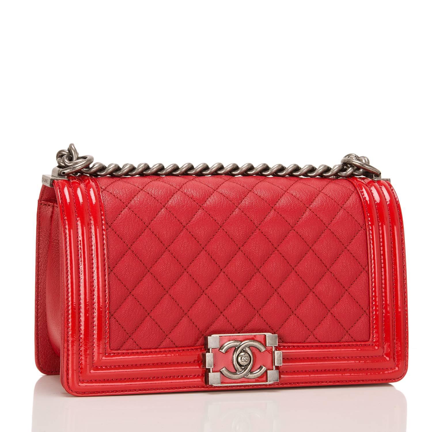 Chanel Medium Boy bag made of red goatskin (chevre) leather accented with patent leather trim and aged ruthenium hardware.

The bag features a full front flap with a limited edition Le Boy push lock CC closure in a glossy red lacquer and ruthenium