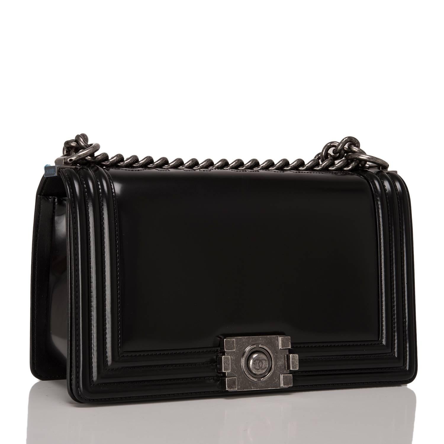 Chanel limited edition, Metiers D'Art Medium Boy bag is made of black smooth calfskin leather accented with aged ruthenium hardware.

The bag features a full front flap with a Le Boy CC logo push lock closure, C-H-A-N-E-L embossed at the spine and