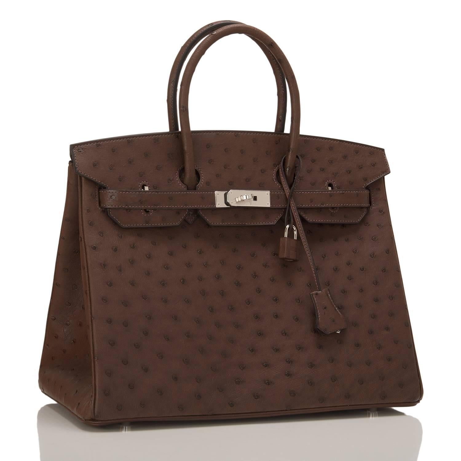 Hermes Marron Fonce 35cm in Ostrich with palladium hardware.

This Birkin features tonal stitching, front toggle closure, clochette with lock and two keys, and double rolled handles.

The interior is lined in Marron Fonce chevre with one zip