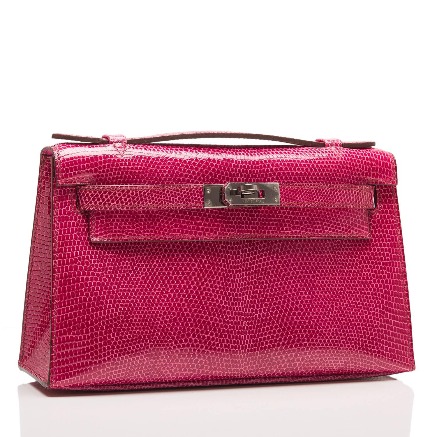  	
Hermes Fuchsia Lizard Mini Kelly Pochette clutch with palladium hardware.

This Hermes Kelly Pochette features tonal stitching, a front flap with two straps, toggle closure and single flat handle.

The interior is lined in Fuchsia H chevre