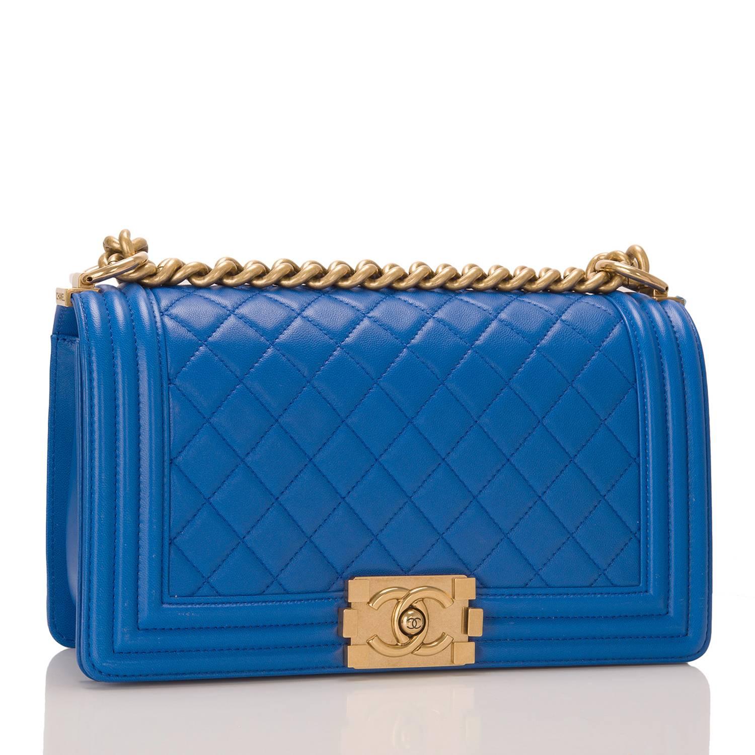 Chanel blue quilted lambskin Medium Boy bag with antique gold tone hardware.

This bag features a full front flap with the Boy Chanel signature CC push lock closure and antique gold tone chain link and blue leather padded shoulder/crossbody