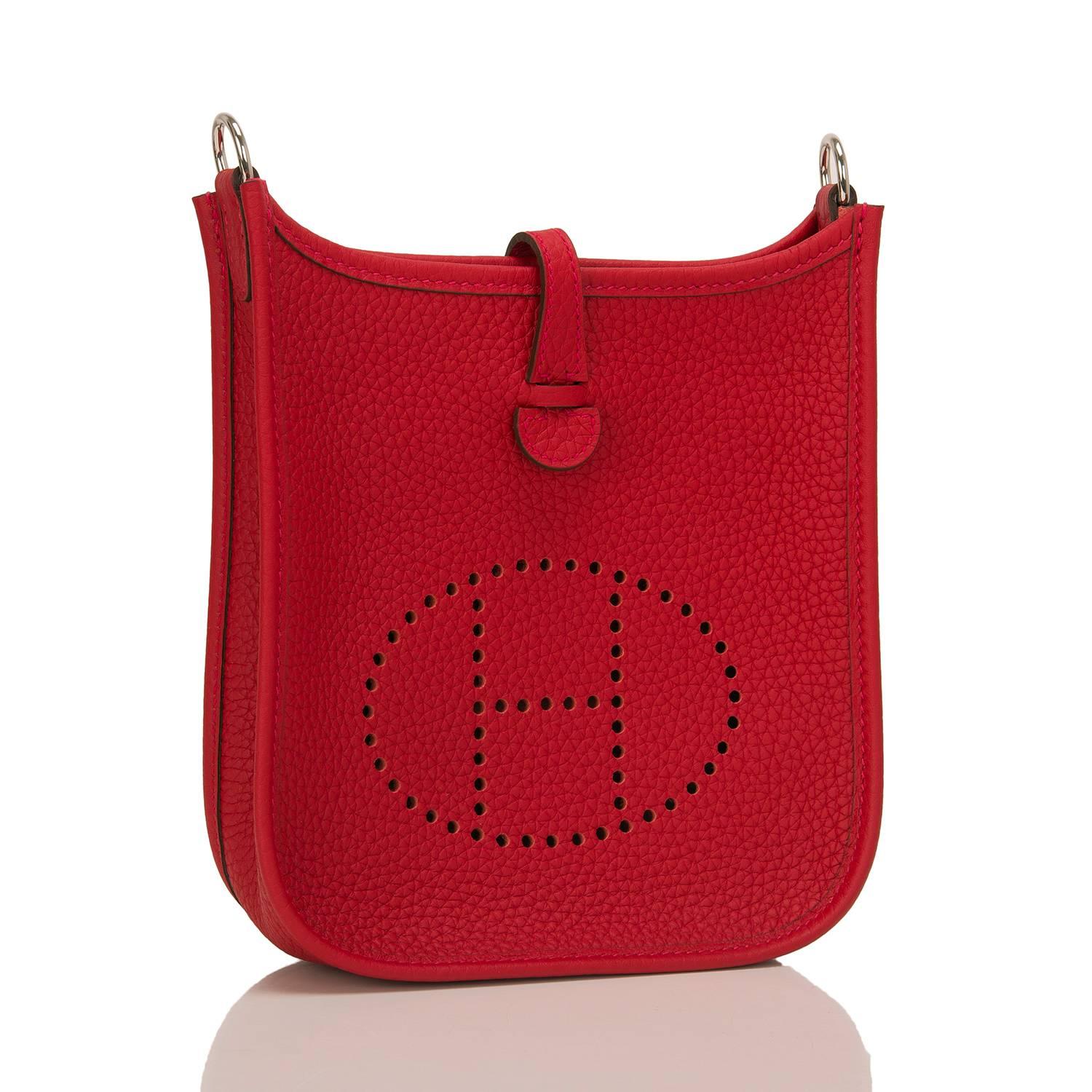  	
Hermes Rouge Casaque Evelyne TPM in clemence leather with bi-color Amazone strap with palladium hardware.

This Rouge Casaque Evelyne TPM features palladium hardware, tonal stitching, large perforated H icon in circle at front, rear pocket, a