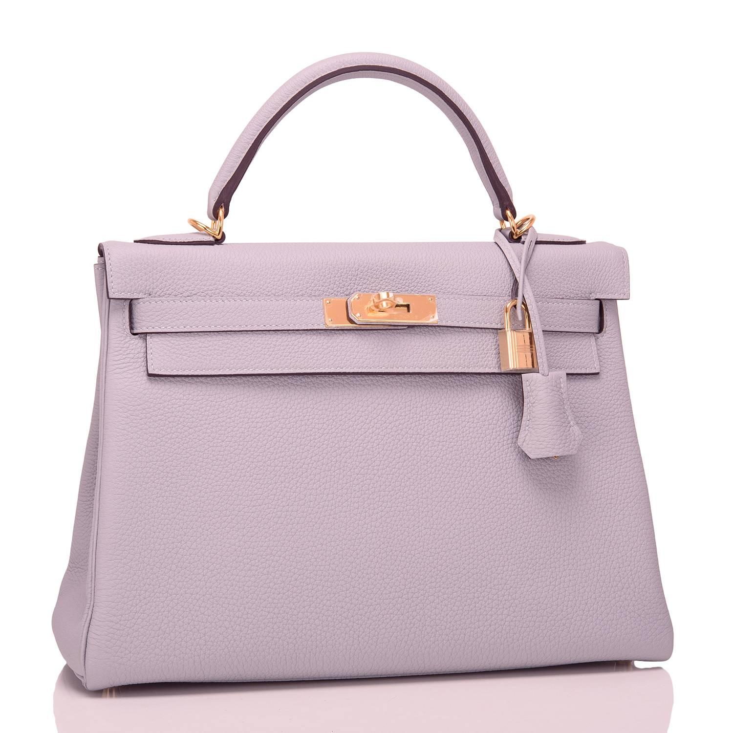 Hermes Blue Glacier (Bleu Glacier) Kelly 32cm of togo leather with gold hardware.

This Kelly, in the Retourne style, has tonal stitching, a front toggle closure, a clochette with lock and two keys, a single rolled handle, and a removable shoulder