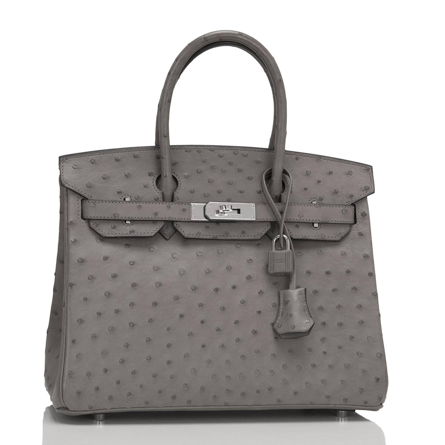 Hermes Gris Tourterelle Birkin 30cm of Ostrich with palladium hardware.

This Birkin has tonal stitching, a front toggle closure, a clochette with lock and two keys, and double rolled handles.

The interior is lined with Gris Tourterelle chevre