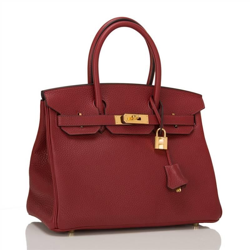 Hermes Rouge H Birkin 30cm of clemence leather with gold hardware.

This Birkin features tonal stitching, a front toggle closure, a clochette with lock and two keys, and double rolled handles.

The interior is lined with Rouge H chevre and has