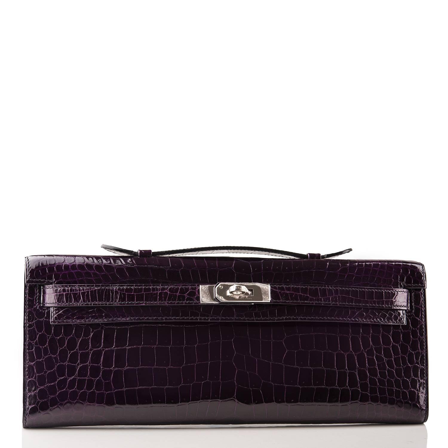 Hermes Aubergine Kelly Cut of shiny porosus crocodile with palladium hardware.

This exotic deep purple Kelly Cut has tonal stitching, front straps with a toggle closure and a top flat handle.

The interior is lined with Aubergine chevre leather and