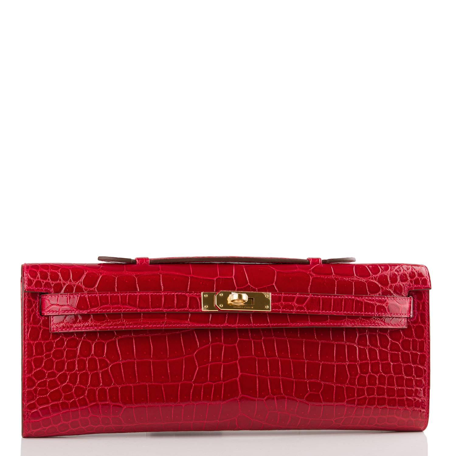 Hermes rare Braise Kelly Cut of shiny porosus crocodile with gold hardware.

This exotic bright red Kelly Cut has tonal stitching, front straps with a toggle closure and a top flat handle.

The interior is lined with Braise chevre leather and has an