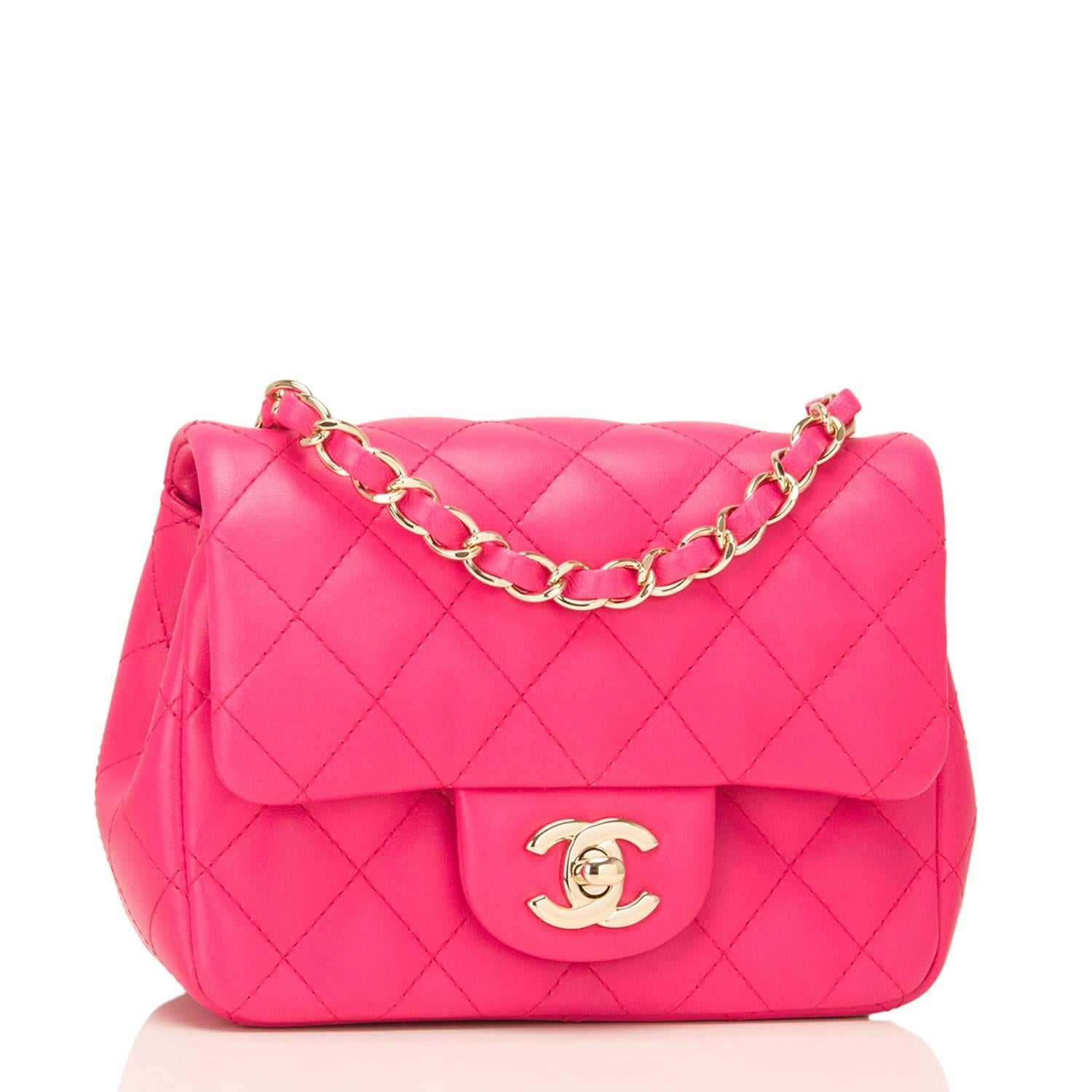 Chanel Square Mini Classic flap bag of fuchsia lambskin leather with silver tone hardware.

This bag has a front flap with CC turnlock closure, a half moon back pocket, and an interwoven chain link with fuchsia leather shoulder/crossbody strap.

The