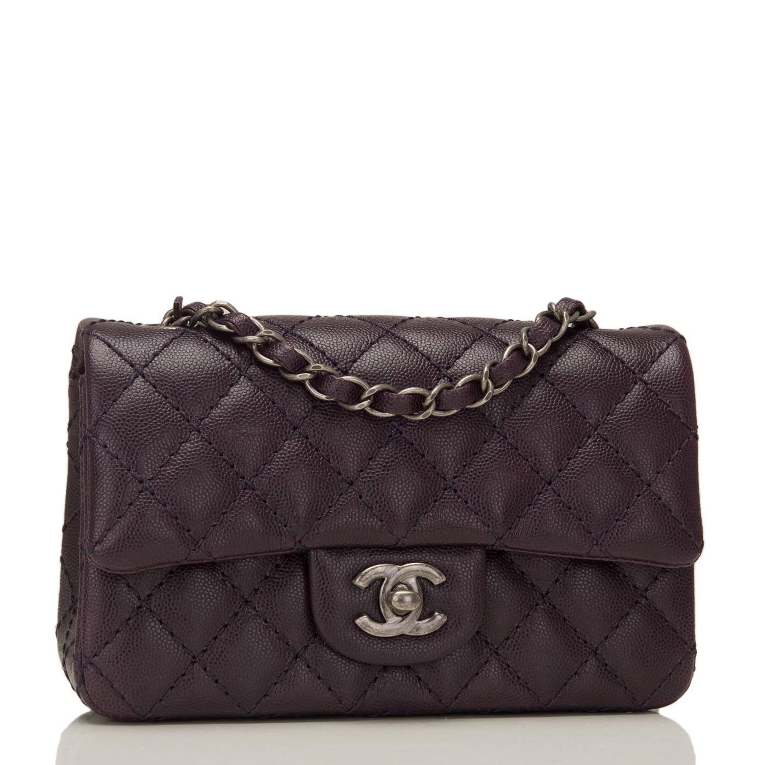 Chanel Rectangular Mini Classic flap bag of dark purple caviar leather with ruthenium hardware.

This bag has a front flap with signature CC turnlock closure, rear half moon pocket and single interwoven dark purple leather and ruthenium tone chain