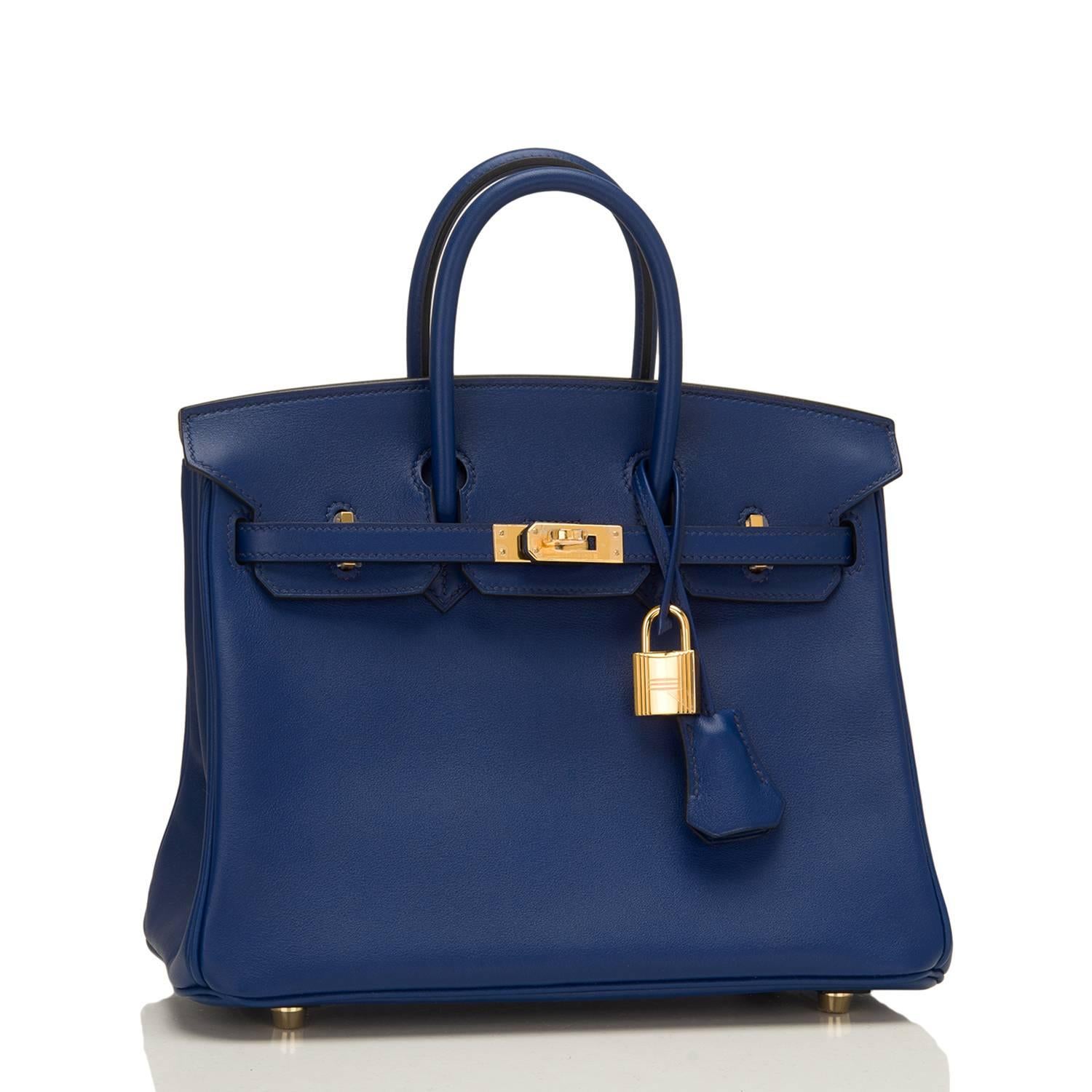 Hermes Blue Sapphire Birkin 25cm of swift leather with gold hardware.

This Birkin has tonal stitching, a front toggle closure, a clochette with lock and two keys, and double rolled handles.

The interior is lined with Blue Sapphire chevre and has