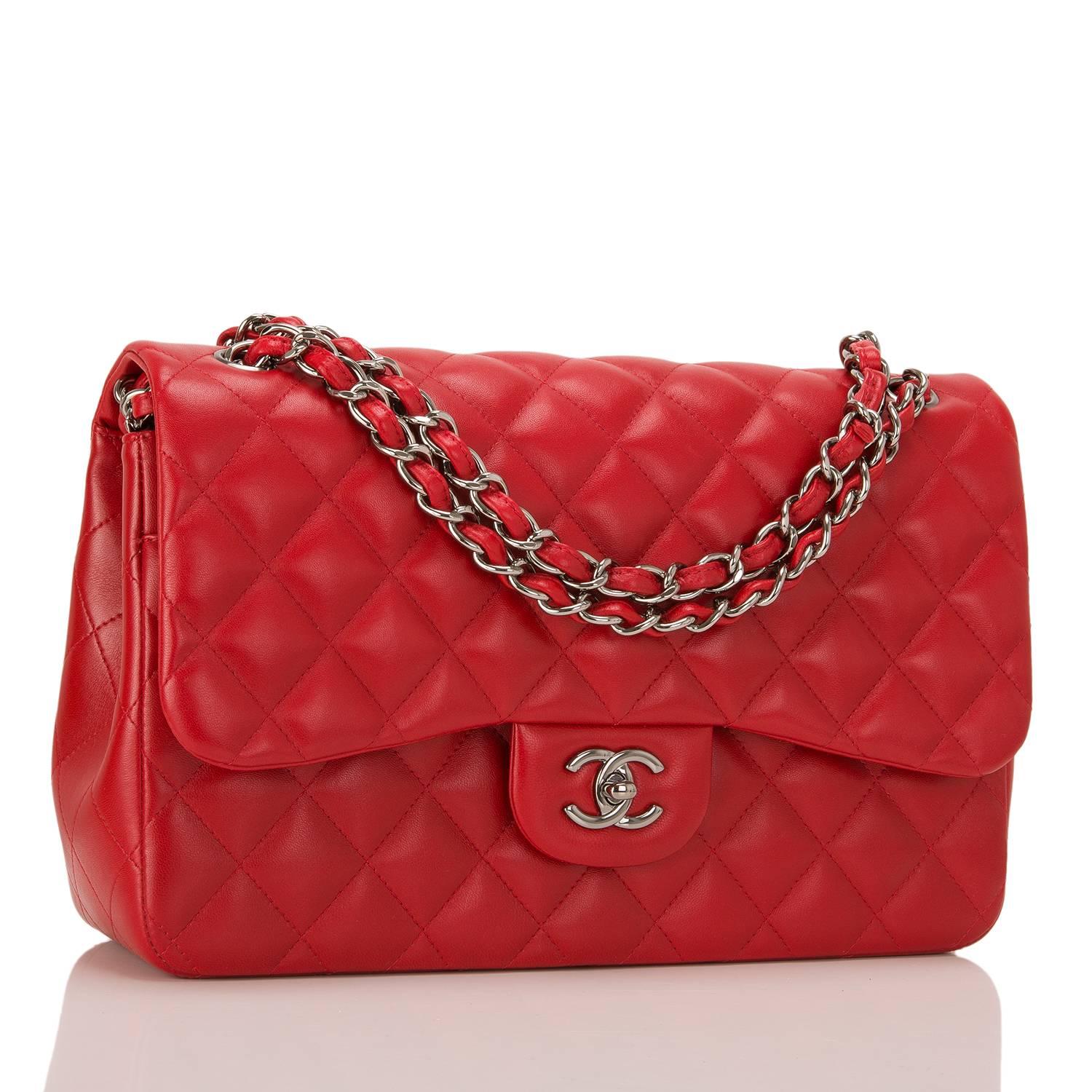 Chanel Jumbo Classic double flap bag of bright red quilted lambskin leather and ruthenium hardware features a front flap with signature CC turnlock closure, half moon back pocket, and an adjustable interwoven aged ruthenium chain link and red
