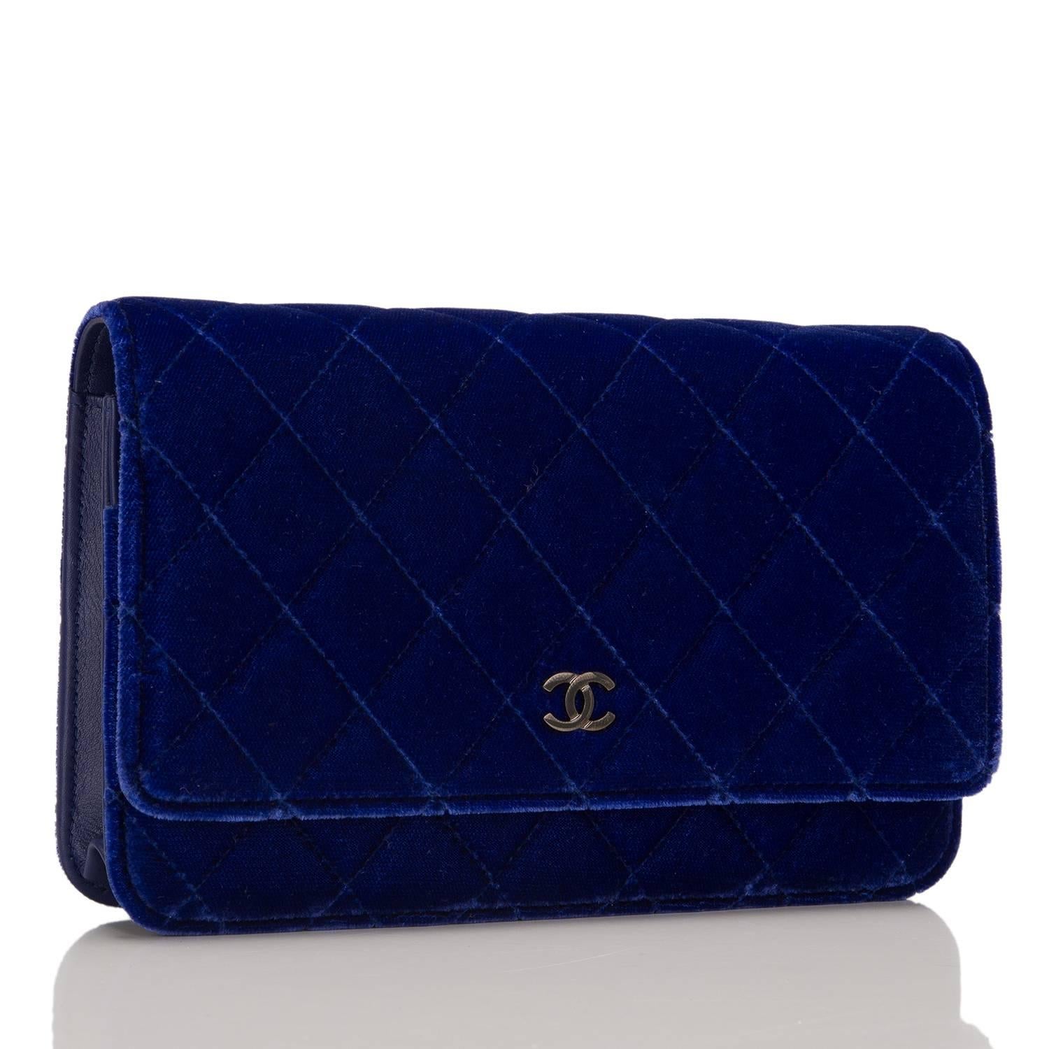 Deep and vibrant, this electric blue velvet Wallet On Chain brings out the beauty of one of Chanel's classic WOC styles. It features signature Chanel quilting, front flap with CC charm and hidden snap closure, expandable sides and bottom, half moon