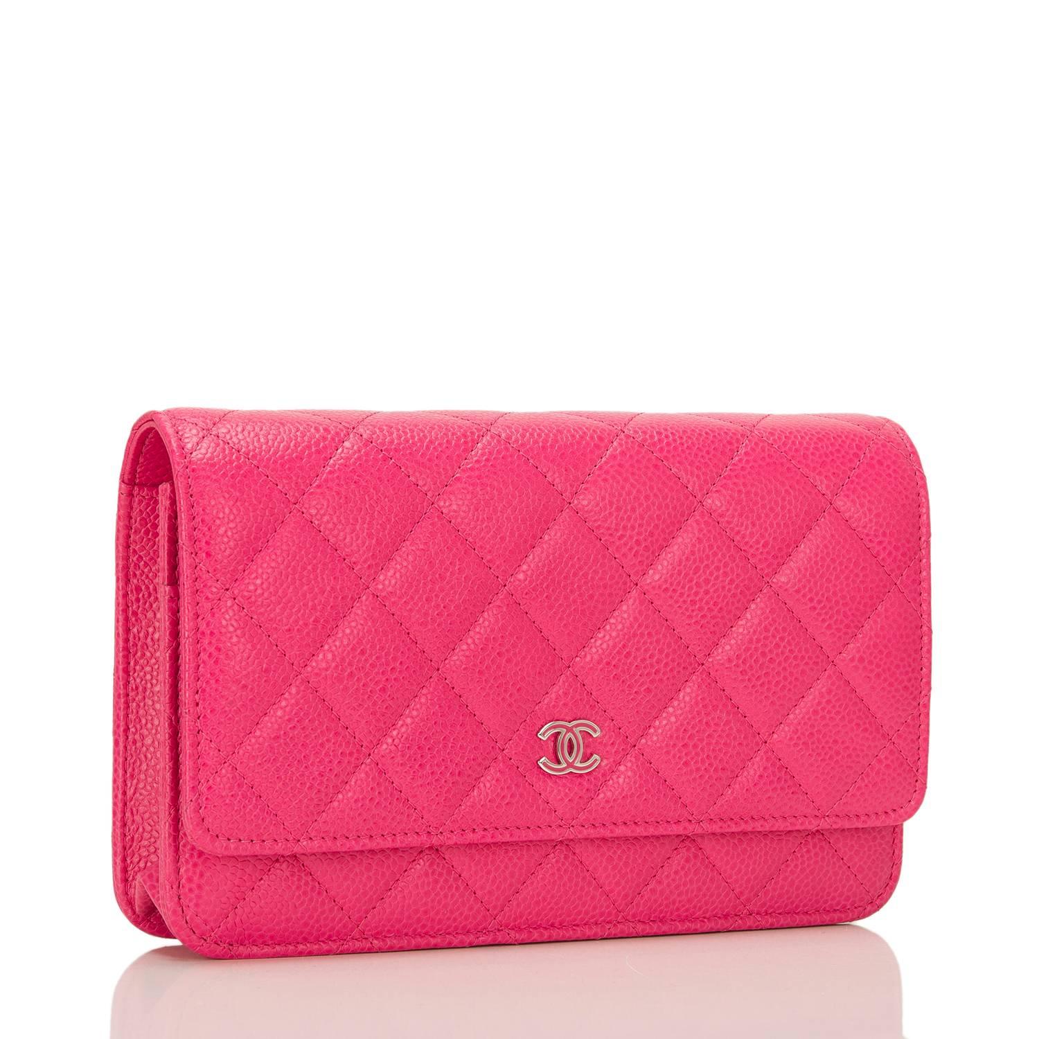This timeless WOC in a bright and beautiful fuchsia color caviar leather features signature Chanel quilting, front flap with CC charm and hidden snap closure, expandable sides and bottom, half moon rear pocket and interwoven silver tone chain and