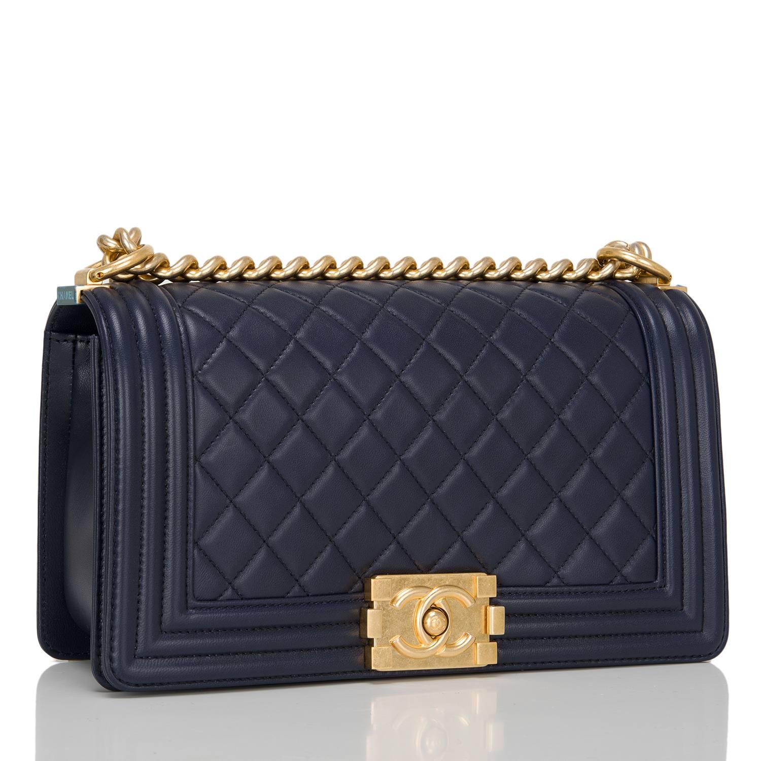 Chanel navy quilted calfskin Medium Boy Bag with aged gold tone hardware.

This Chanel bag features a full front flap with the Boy Chanel signature CC push lock closure and aged gold tone chain link and navy leather padded shoulder/crossbody
