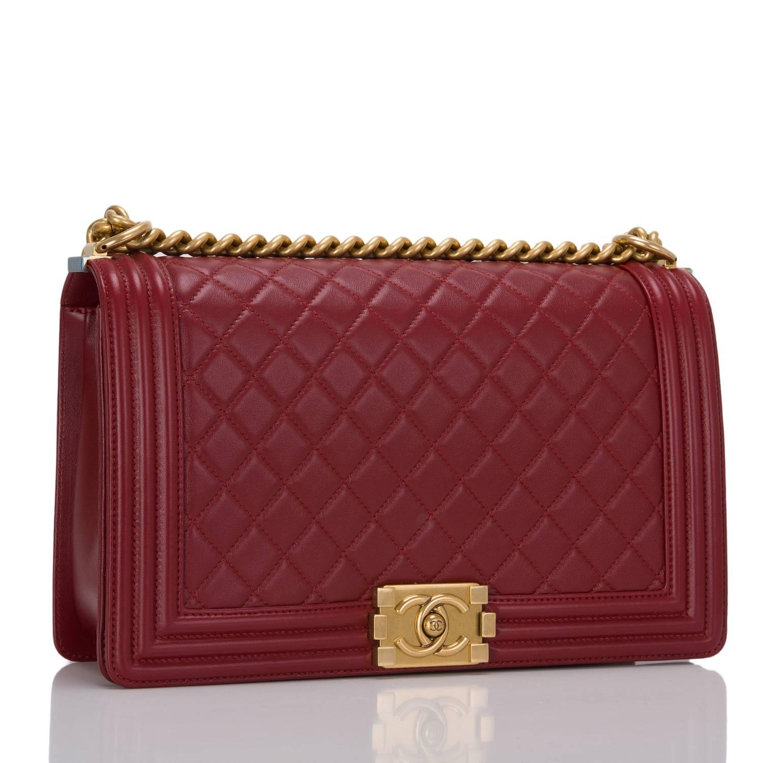 This New Medium Boy bag is made of dark red lambskin leather and accented with antique gold hardware.

The bag features the classic Boy style with a full front flap with the Boy signature CC push lock closure and an antique gold chain link and