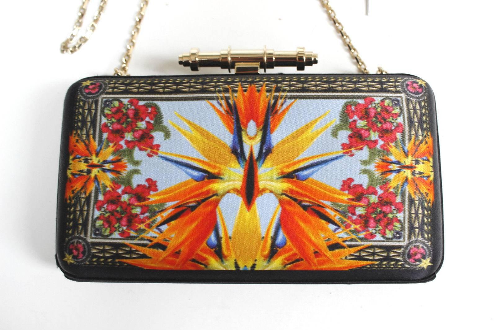 Black and orange satin Givenchy Obsedia minaudiere with bird of paradise motif, gold tone hardware, 
Detachable gold chain strap and flip-lock closure at top
Excellent condition