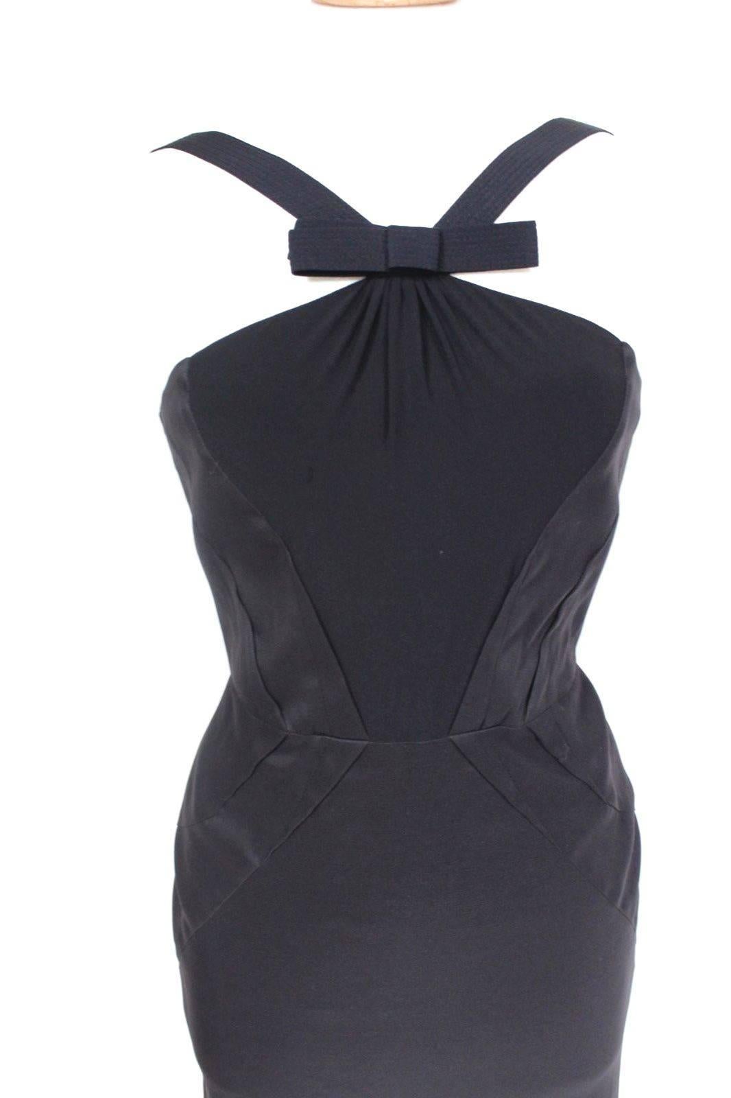 Versace Little Black V Neck Dress 38 uk 6 
Special little black dress from Versace A/W 2006 collection 
Featuring front V straps with bow
Fully lined with slimming centre seams effect 
 76% silk, 18% nylon, 6% elastane. 
Length 38 inches, chest