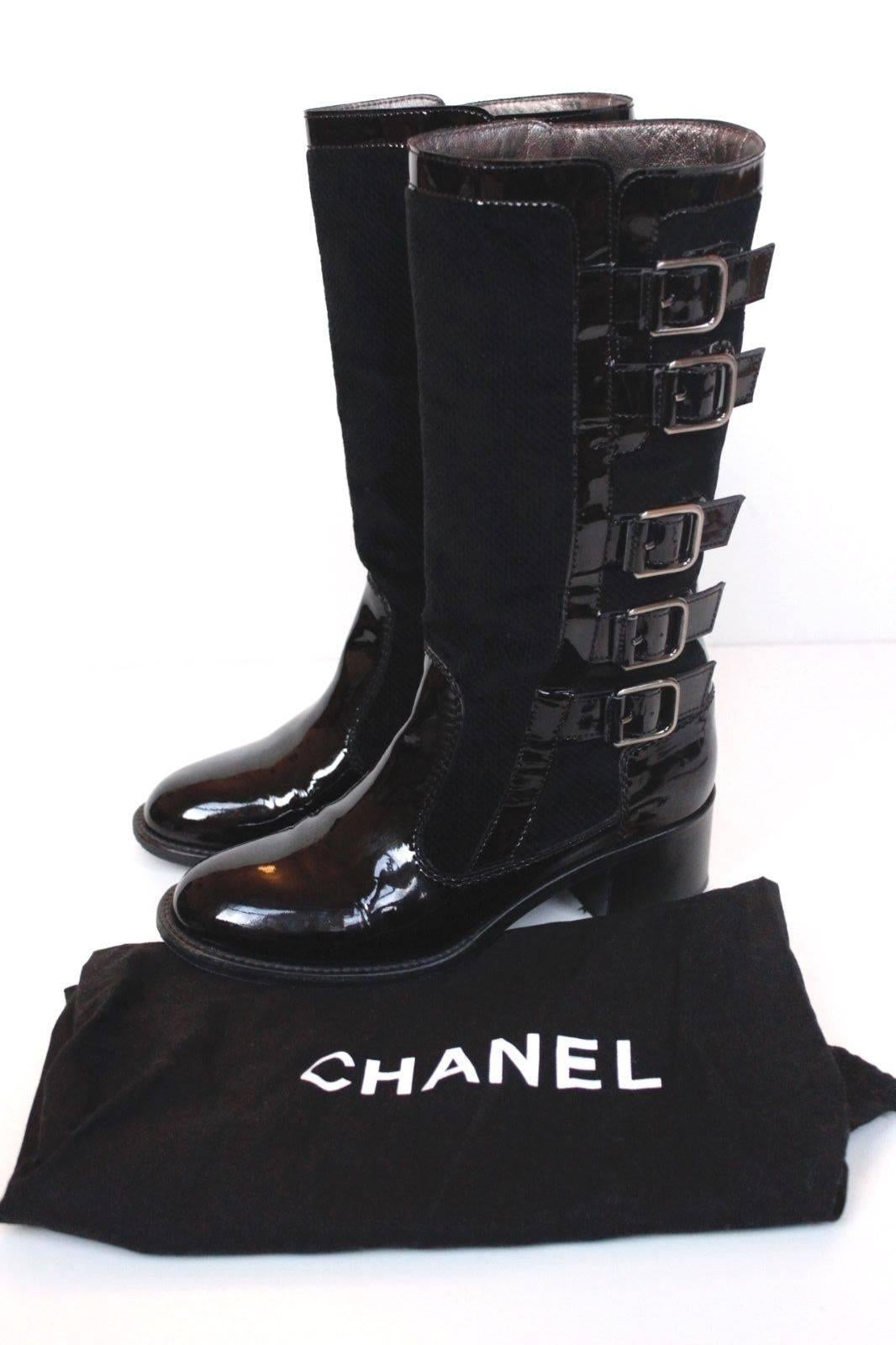 CHANEL Black Patent Leather Multi Buckle Boots 36.5 UK 3.5 
Gorgeous Moto Biker boots from Chanel featuring suede cord with patent leather buckle overlay
Pull on style with Chanel patent tab to the inner side 
As with most Chanel shoe sizes, its