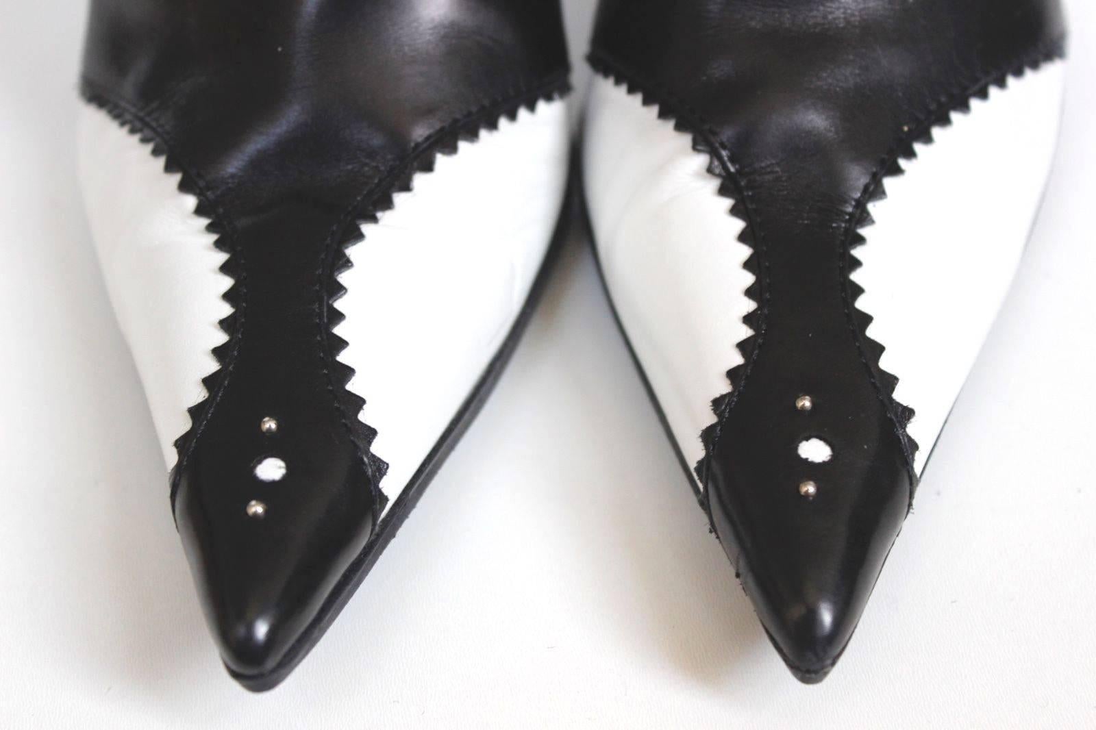 Christian Dior D'Trick John Galliano S/S 2004 Black White Pearl Boots 38 UK 5

Inspired on german actress Marlene Dietrich these boots has a pearly strings and pretty scallop pattern with perforations.
 From the Spring 2004 Collection.
Size:
