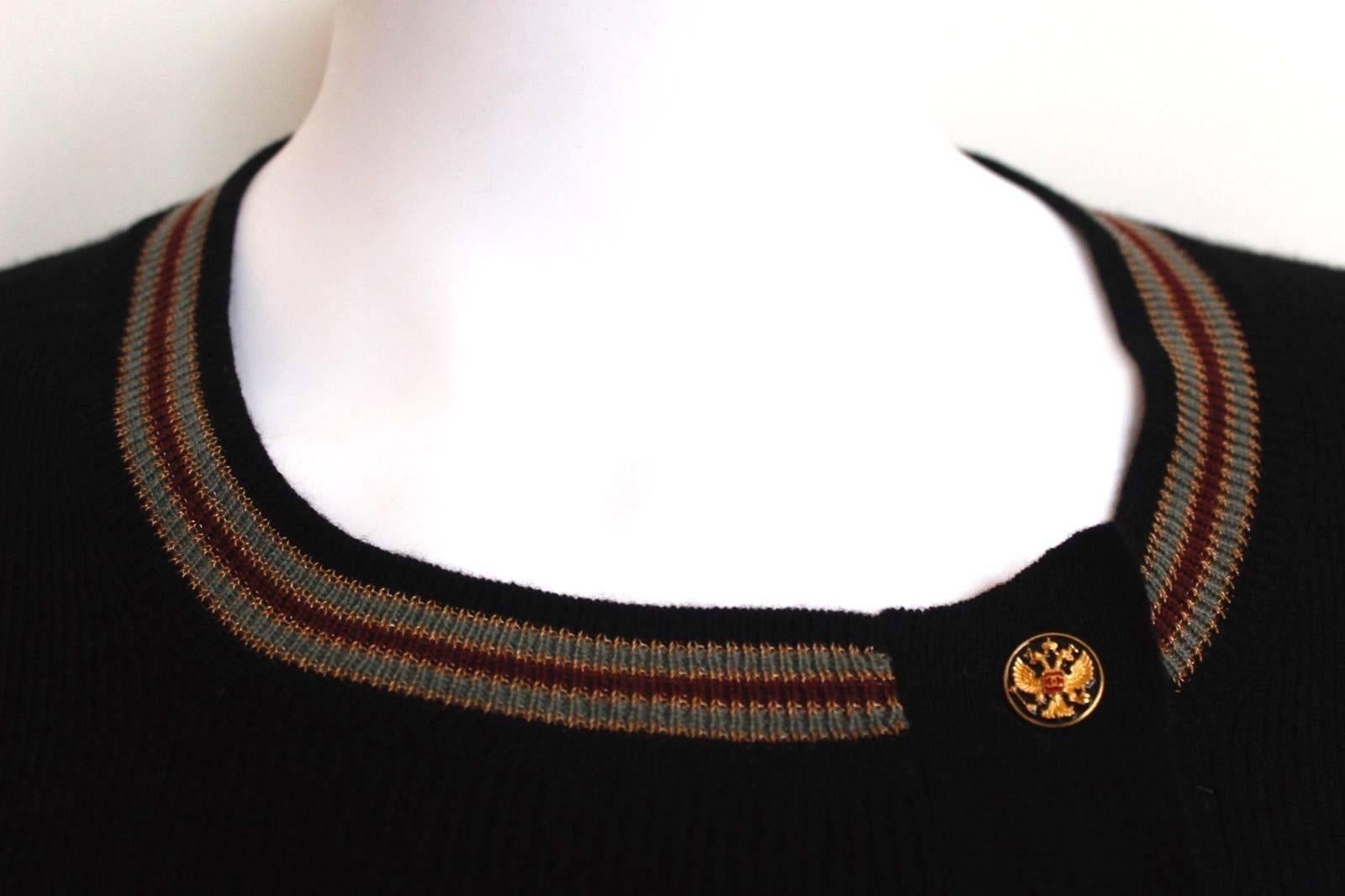 Chanel Black Cashmere fine Knit Moscow A 2009 Collection Top F40 uk 12 
Lovely fine cashmere knit top from Chanel featuring gold red strips to the neck line and cuffs
Off centre CC Logo eagle buttons to the front 
95% cashmere 3% Viscose, 2%