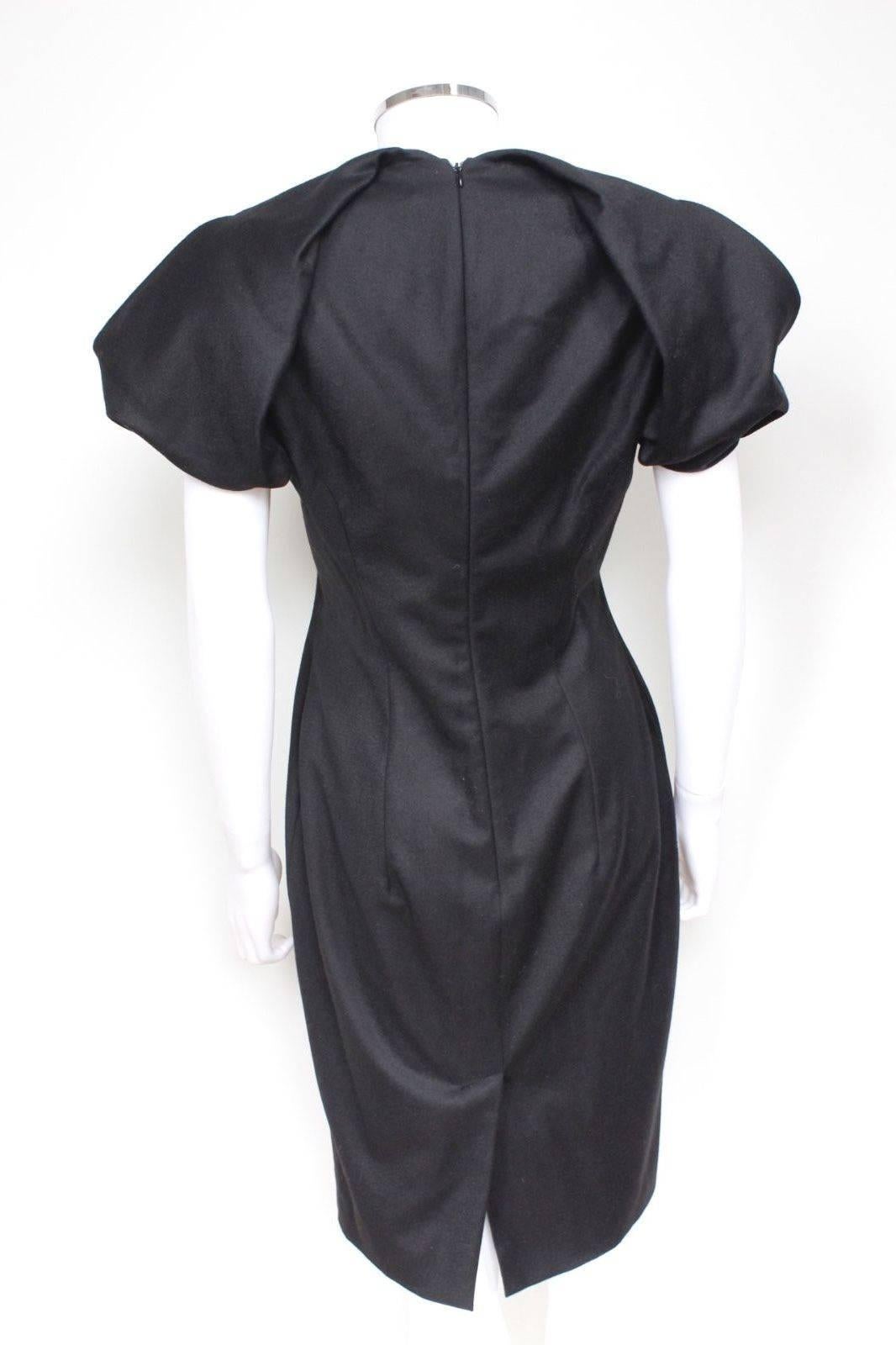 ALEXANDER MCQUEEN Black Wool-crepe Pleated Shoulder Dress It 44 uk 12 
Black wool-crepe dress from Alexander McQueen featuring exaggerated pleated cap sleeves, a v- neck, split hem to the back and concealed zip at rear for closure. 
The dress is