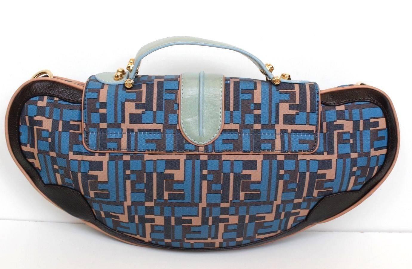 FENDI BLUE PINK LEATHER ZUCCA CANVAS VANITY CLUTCH BAG
This celebrity-loved Fendi Blue Zucca Canvas Vanity Clutch/Bag is the kind of bag we love to carry. 
It features a mix of Fendi Zucca print canvas with leather accents and a hinged leather