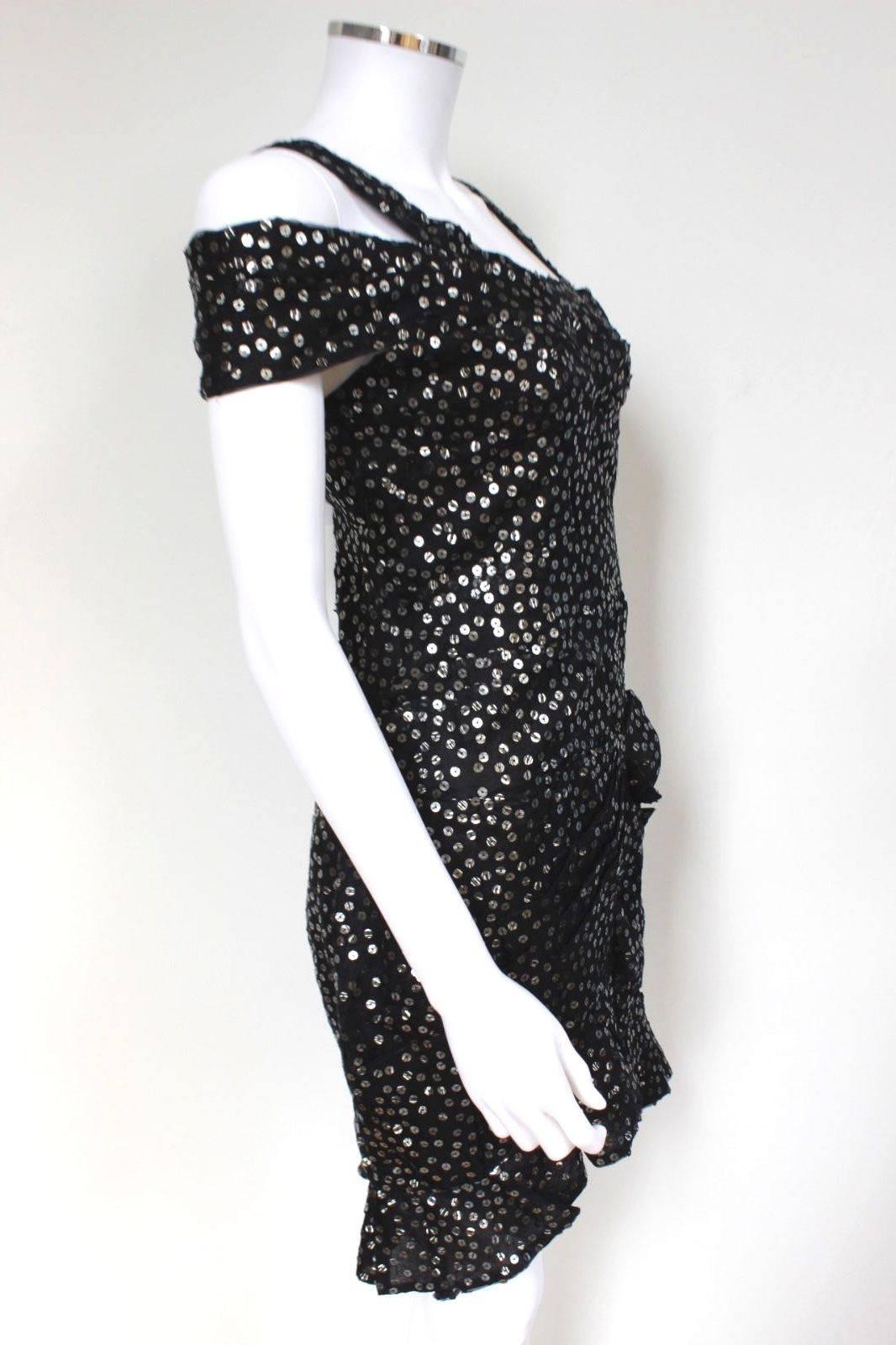 New ISABEL MARANT Black Silk Sequins Becky Dress Size 36 uk 8 
This flirty Isabel Marant Becky dress is an eye-catching addition to any wardrobe. 
Featuring a fabulous sheer silk in black covered in silver sequins, this dress has subtle pleated and