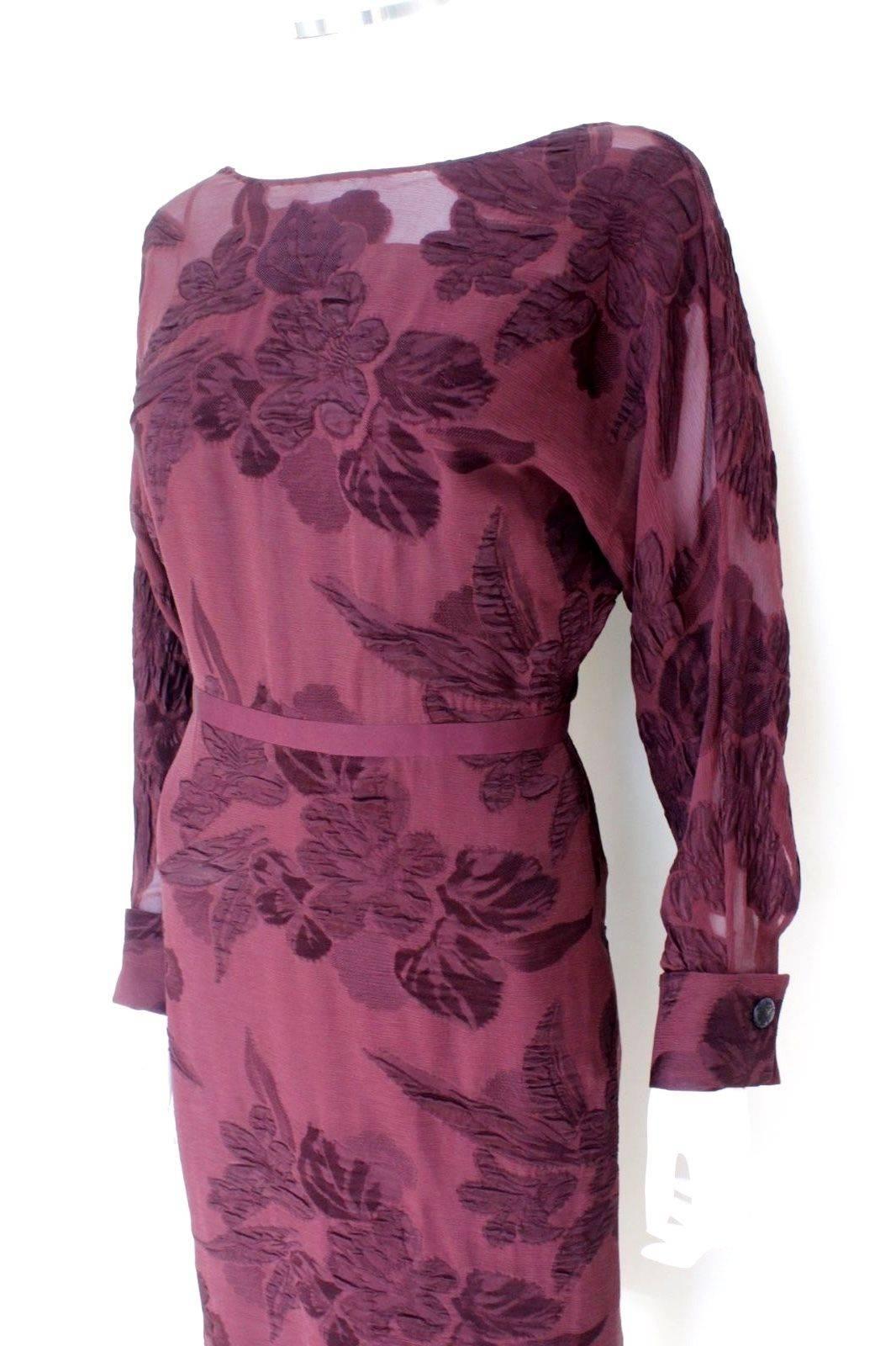 Gucci A/W 2012 Catwalk Burgundy Floral Sheer Dress It 38 UK 6 
Beautiful dress from Gucci featuring semi sheer bodice with under slip 
Batwing style long sleeves with logo cuff links 
Concealed zip fastening to the back 
61% Acetate 39%Silk 
Length