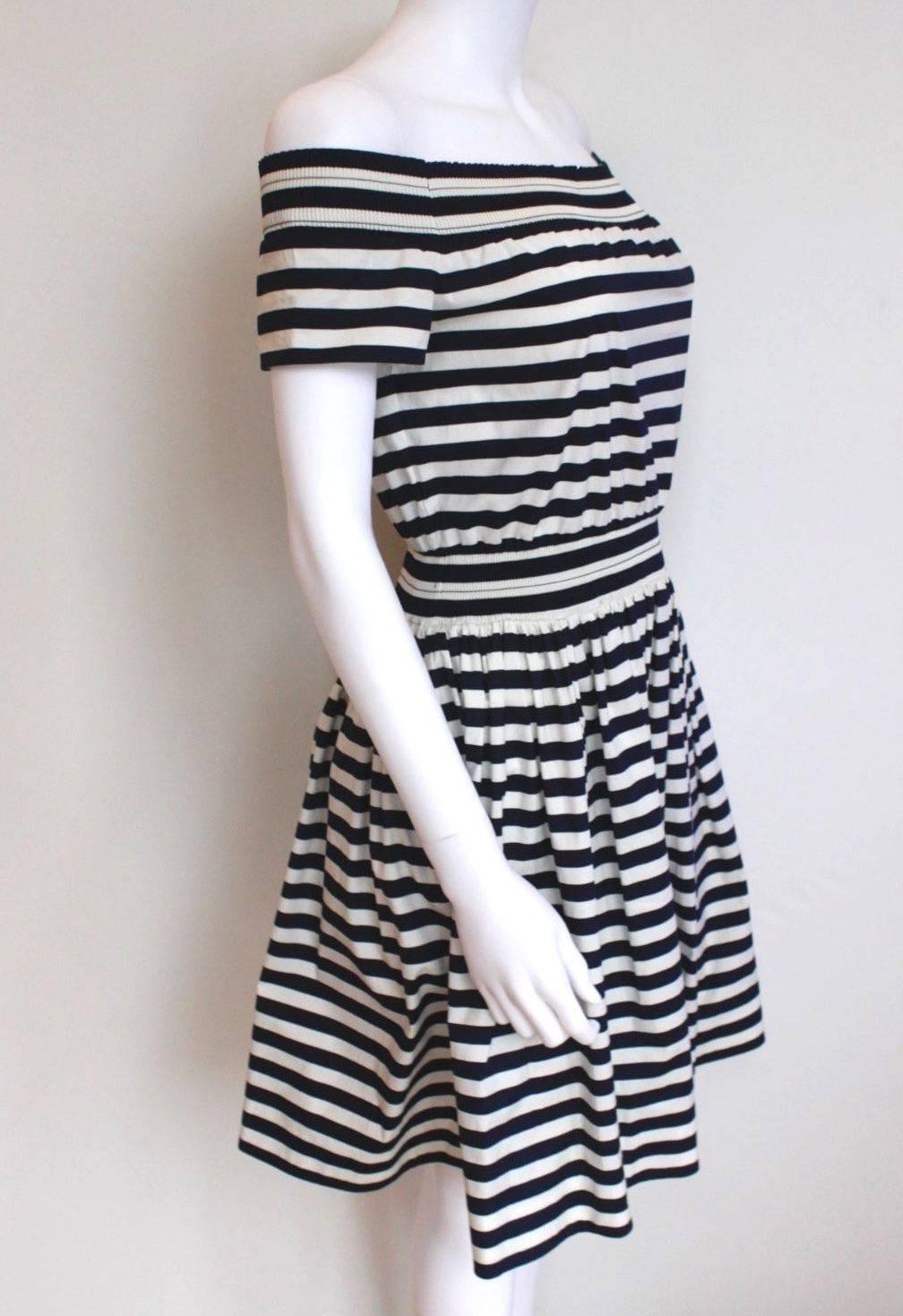 New Prada Cotton Navy striped Dress 42 uk 10 
Light wight cotton dress from Prada featuring elasticated waist and shoulders
Dark navy stripes
New, excellent condition 
