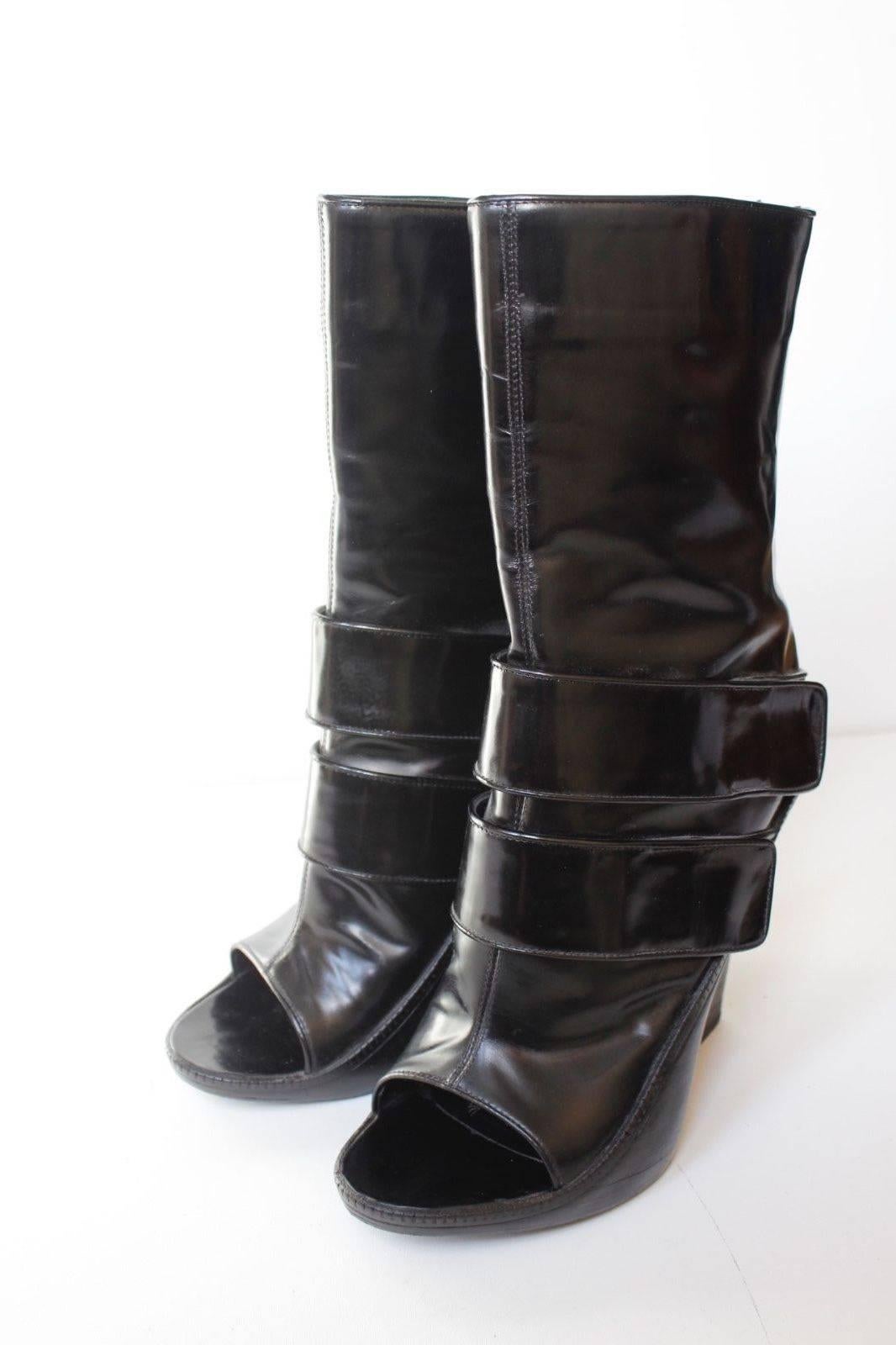 Givenchy Black Patent Leather Wedge Midi Boots 40.5 uk 7.5
Black patent leather Givenchy peep-toe wedge boots with dual strap accents at top lines, stacked heels and zip closures at shafts. 
5.5 inch wooden wedge heel 
Excellent condition

