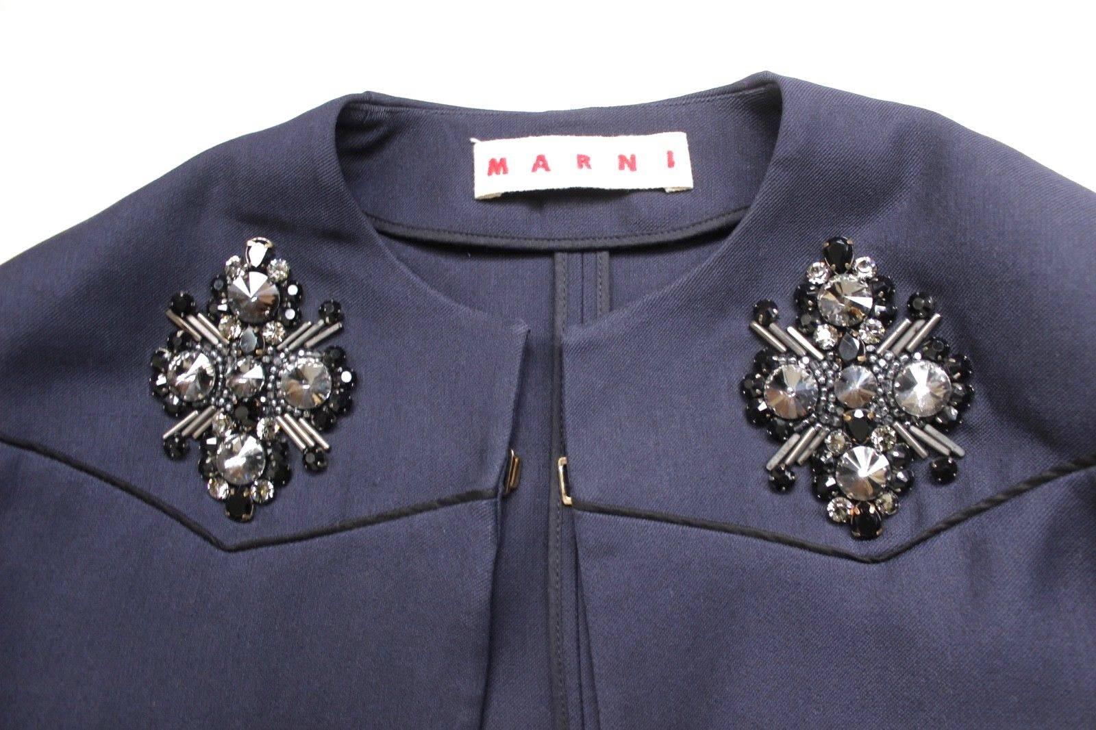 £1300 Marni Embellished Navy Coat It40 UK 8 
Lovely evening coat from Marni with crystal beaded embelishment to the chest 
Front clasp fastening , not lined, light weight coat
50% Wool 50% Silk 
Length 40 inches, chest 19.5 inches across, hips 21