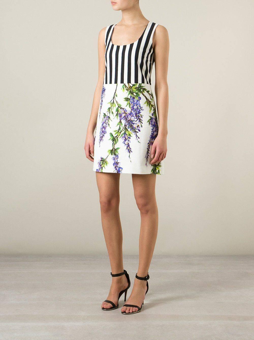 New Dolce and Gabbana White Striped Wisteria Floral Mini Dress 40 UK 8  
Black, white and purple silk and stretch cotton blend striped wisteria print dress from Dolce & Gabbana featuring a scoop neck, a sleeveless design and a rear zip fastening. A