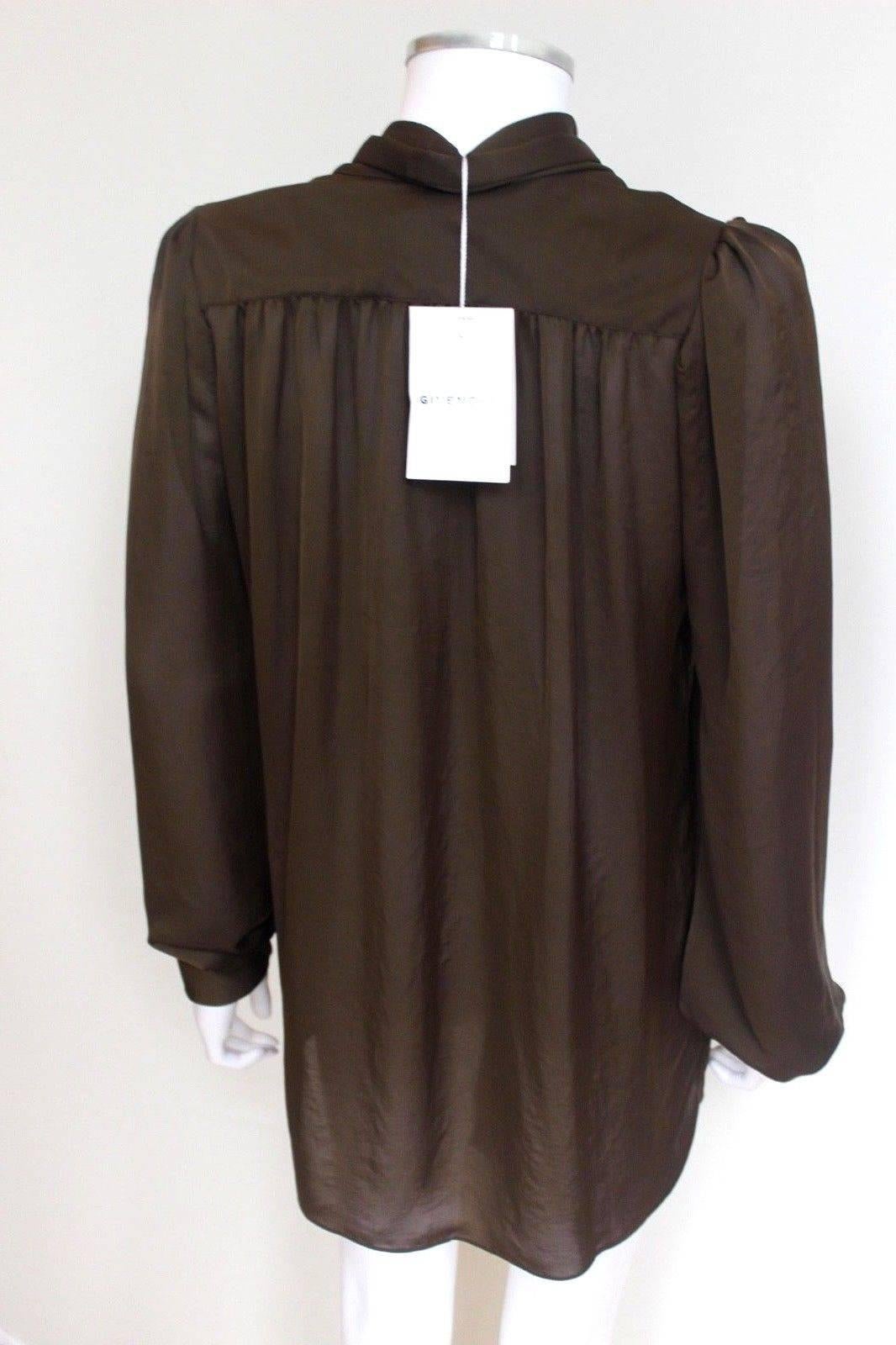 £1500 Givenchy Ruffle Front Blouse F 40 UK 12 
Button front blouse with ruffle panels at front and tie at collar 
buttoned cuffs 
Brown/Olive in colour 
Length 28 inches, chest 21 inches across laid flat. 
Excellent condition, any questions please
