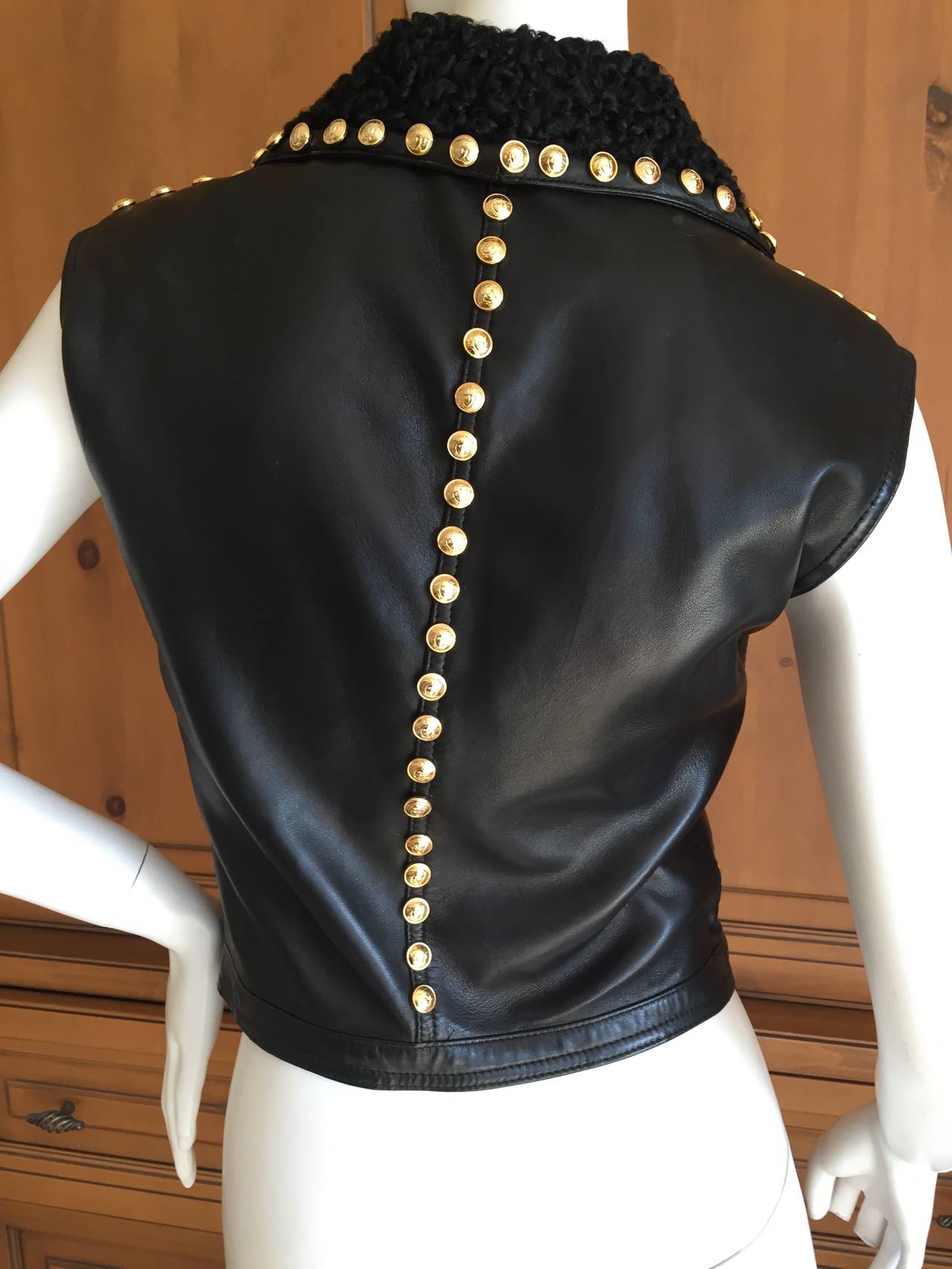Iconic 1992 black leather vest with lamb fur collar and dozens of golden Medusa head studs.
This piece was immortalized in the Irving Penn photographs in the 1992 Versace look book on Karen Mulder and Christy Turlington.
Sz Small